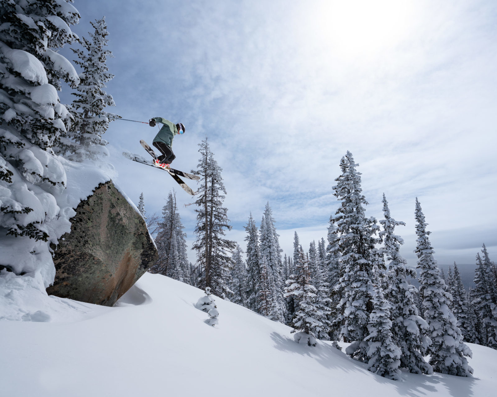 skier jumping off a rock